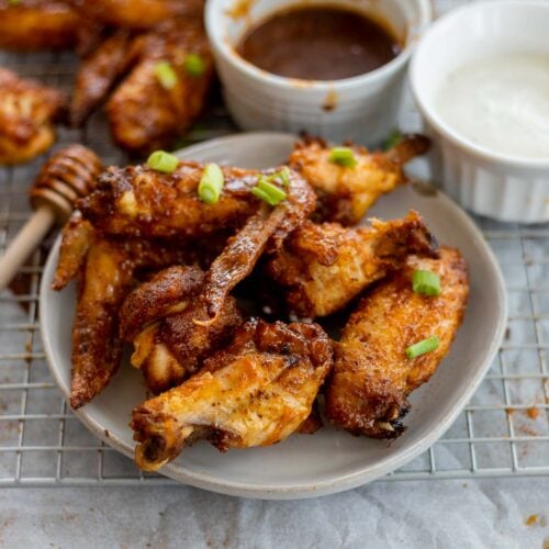 A plate full of Honey Old Bay Wings served with the homemade honey old bay sauce and ranch dressing.