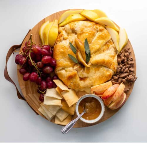 Pear Baked Brie with sliced pears, sliced apples, almonds, grapes, nuts and pear jam