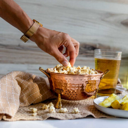Reaching for a bite of salty and tangy Dill Pickle Popcorn