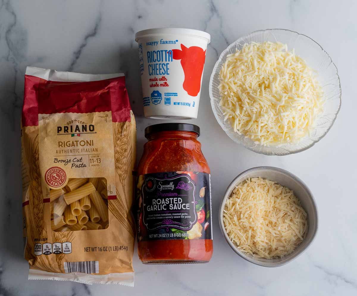 5 Ingredient Baked Ziti ingredients: rigatoni noodles (substitute for ziti noodles), tomato sauce, ricotta cheese, mozzarella cheese and parmesan cheese