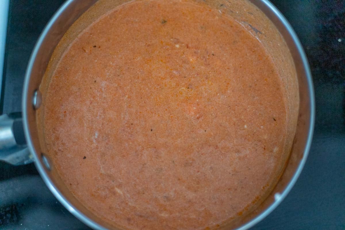 Mixing tomato sauce and ricotta cheese together to make a creamy sauce for the 5 ingredient baked ziti (kraft copycat recipe)