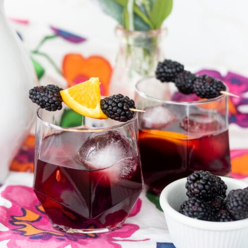 A refreshing glass of Blackberry Sangria garnished with blackberries and orange slices.