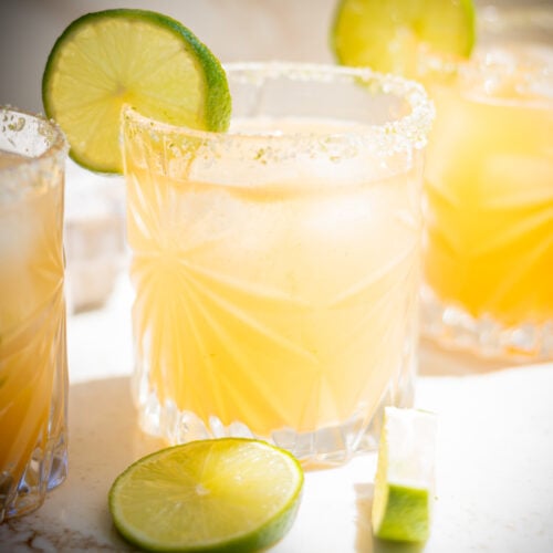 Margarita in a glass garnished with a lime wheel.